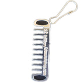 Grim Workshop Comb Micro Tool clipped to a zipper for quick grooming on the go.