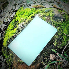 Grim Workshop glow card charging in sun for long-lasting visibility.