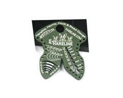 Hareline Dubbin olive gauge tool close-up for precise hook, hackle, and bead sizing.