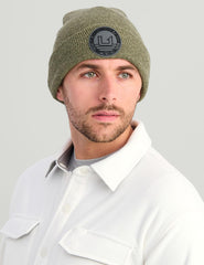 HUK embossed beanie outdoor styling on trail illustrates versatile warmth