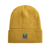 HUK Beanie logo detail shows brand on soft knit warmth.