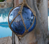 Royal blue Japanese glass fishing float with natural jute rope - front view