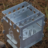 Kamp Ayisi multi-fuel stove with bag for portable cooking on outdoor adventures.