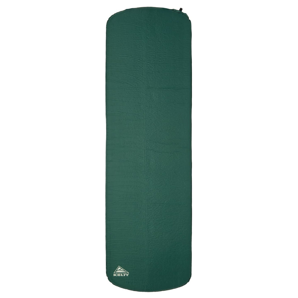 Kelty Mistral self-inflating mummy pad during setup for quick camping comfort.
