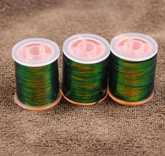 KTGCOZS Peacock flat tinsel nylon closeup reveals flexible thread for precise wraps.