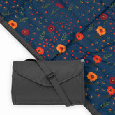Little Unicorn picnic blanket midnight poppy folded for easy transport and storage.