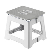 Lovskoo plastic mini stool folded for easy transport and quick setup.