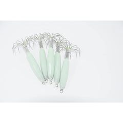 Luminous squid jig hooks glow for enhanced night fishing visibility under low light.