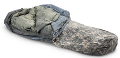 Military Outdoor Clothing ACU digital modular sleeping bag system in foliage, field-ready and adaptable for overnight trips.