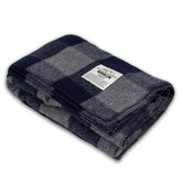 Minus33 Camp Throw Blanket in buffalo plaid offers warm comfort for outdoor camping.