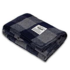 Minus33 Camp Throw Blanket in buffalo plaid offers warm comfort for outdoor camping.