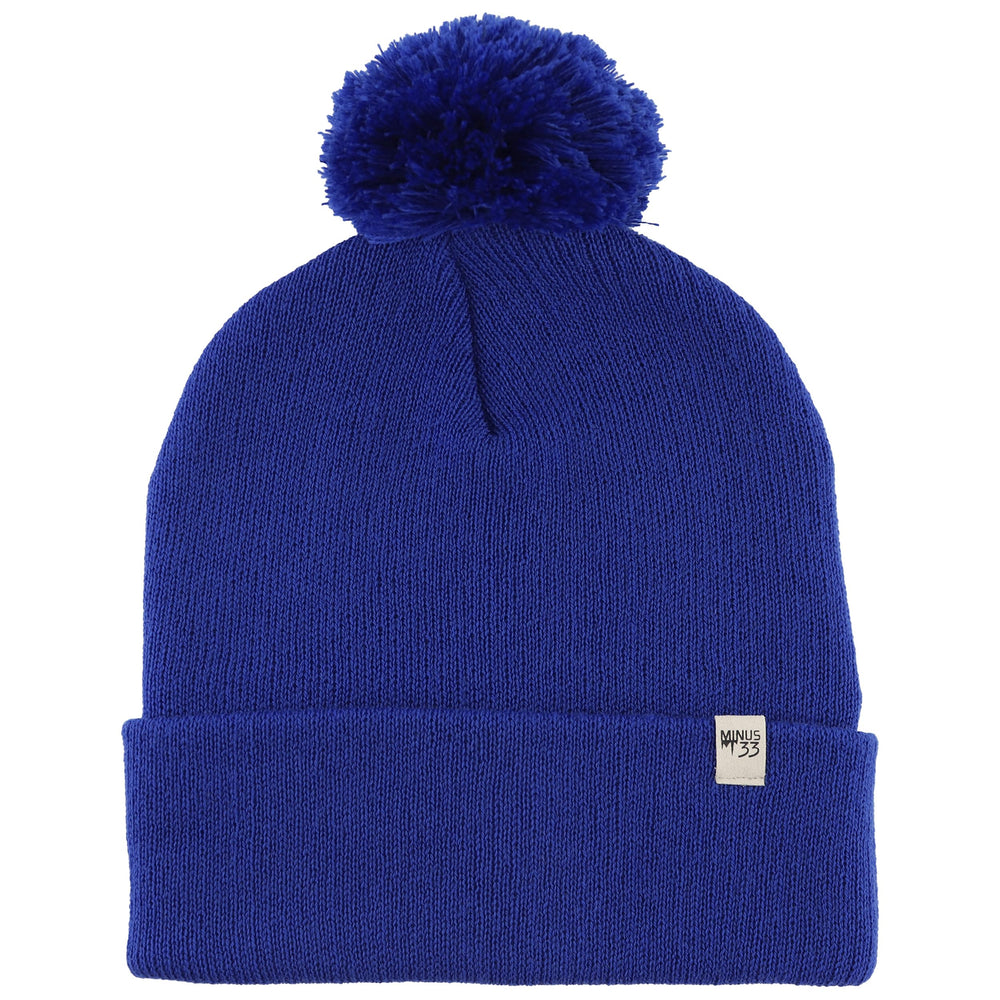 Minus33 Merino midweight pom beanie in royal blue viewed from the front, cozy warmth.