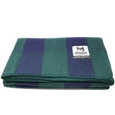 M MCGUIRE GEAR warm wool bunkhouse blanket draped over campsite chair for warmth.