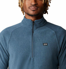 Mountain Hardwear MicroChill 1/4 Zip Pullover Montauk Blue Heather emblem closeup shows rugged styling and logo detail.