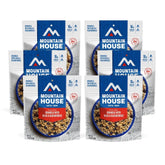 Mountain House granola with milk and blueberries pouch-prepare demonstrates quick trail-ready meal.