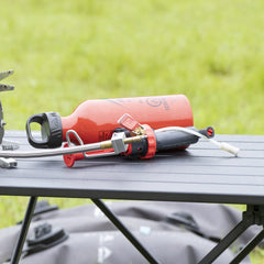 MSR pump weighs 2.3 oz, shown compact for lightweight backpacking