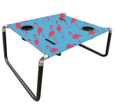 Neso Beach Table setup with flamingos keeps drinks within reach on the sand