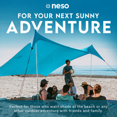 Neso Gigante 8ft-tall shade covers kids and chairs at the beach.