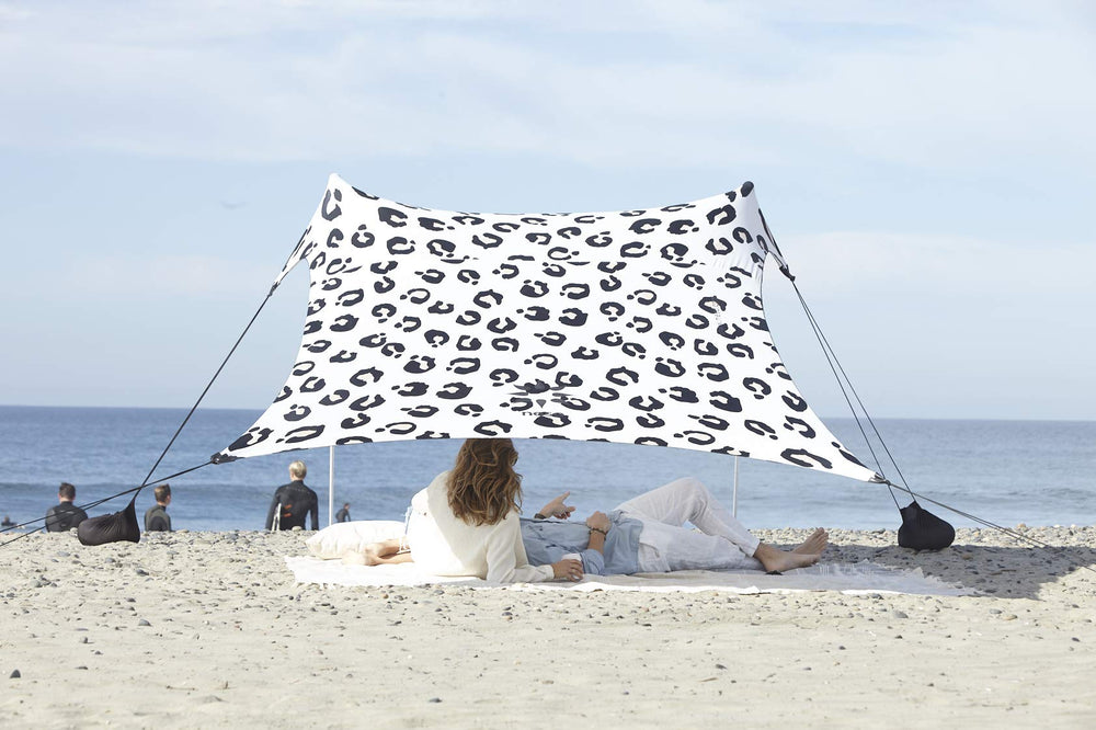 Neso Leopard tent assembled on the beach delivering quick shade and airflow.