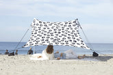 Neso Leopard tent assembled on the beach delivering quick shade and airflow.