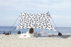 Neso Leopard tent assembled on the beach delivering quick shade and airflow.