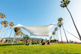 Neso Party Tent 11x22ft on the beach, stable shade for sun and wind.