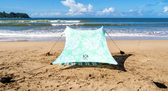 Neso portable beach tent mint tie-dye ready for setup to provide shade.
