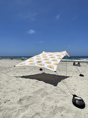 Neso sand anchor bags stabilizing the canopy for stable beach shade.