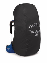 Osprey ultralight raincover fitted on a black backpack protects gear in rain