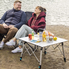 OuterSpa portable camping table setup on uneven terrain showing adjustable legs