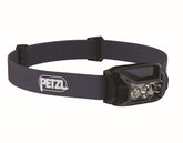 PETZL ACTIK headlamp on forest trail provides hands-free lighting for night hikes.
