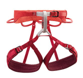 Petzl Luna harness front view in coral red for secure women-specific fit.