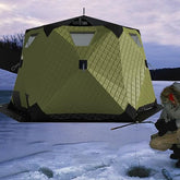 Portable hexagon ice shelter with stove jack for warmth on icy trips.