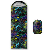 QOOMO neon dinosaur sleeping bag outer-material close-up shows waterproof, breathable fabric for outdoors
