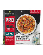 ReadyWise Outdoor Pro beef bulgogi kimchi rice pouch on trail for high-protein energy.