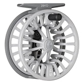 Redington ZERO reel in wolf grey held for lightweight trout fishing control.