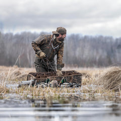 Rig Em Right Mossy Oak Shadowgrass camo bag blends into marshy surroundings.