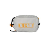 RiverSmith PackOut hip pack worn during river wading, compact and organized.