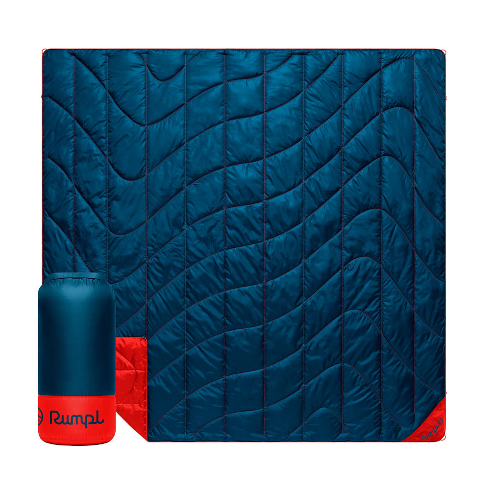 Rumpl Backcountry Puffy Blanket packed in roll-top bag for portable warmth on outdoor trips