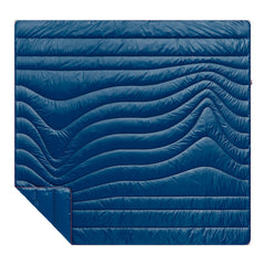 The Rumpl Original Puffy 2P blanket packed in its roll-top sack for easy portability.