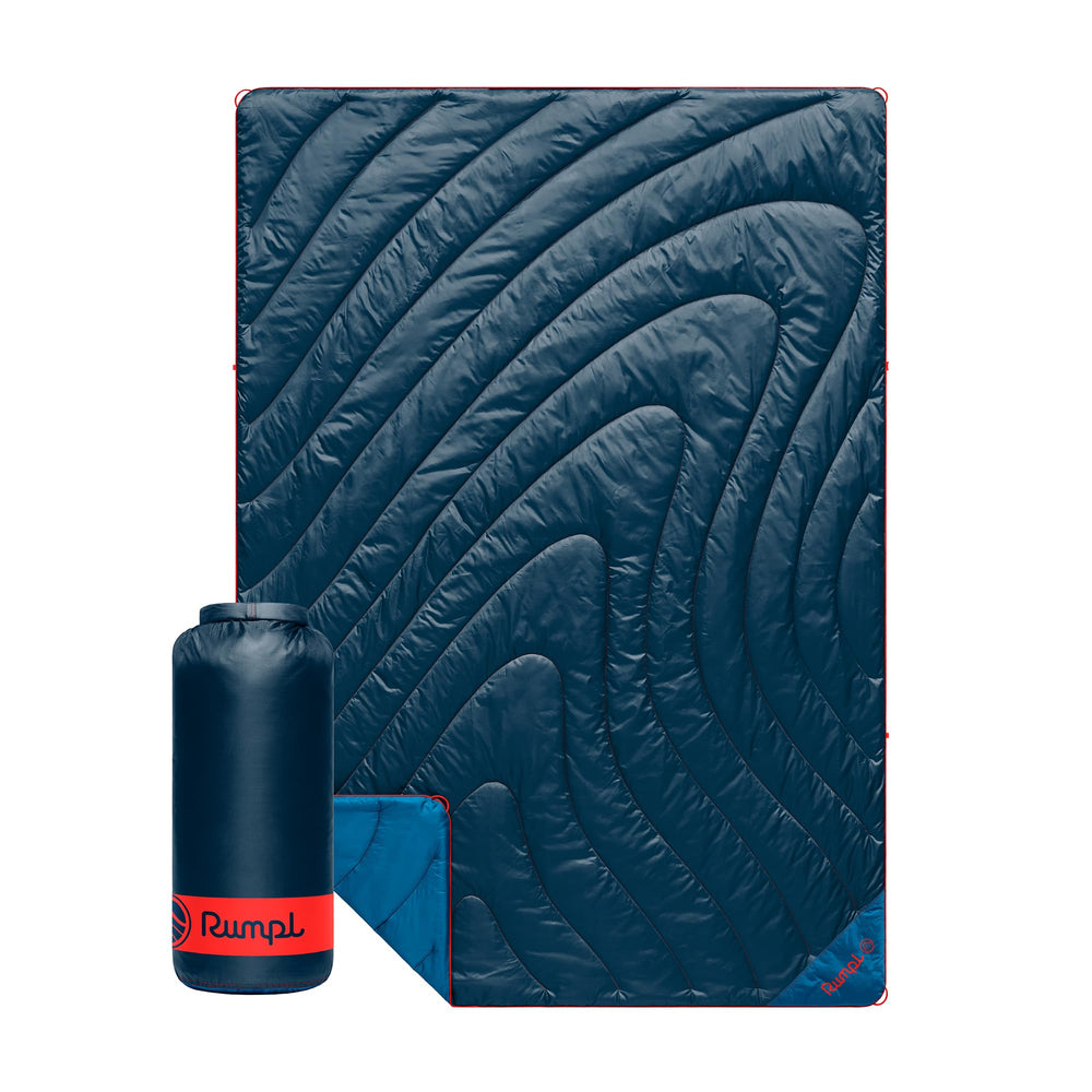 Rumpl Original Puffy Blanket Deepwater rolled compact for outdoor portability.