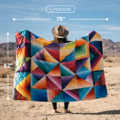 Rumpl Original Puffy Blanket Ocean Fade spread across a picnic table