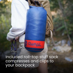 Rumpl Original Puffy Blanket rolled in roll-top sack shows easy packing for trips.