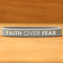 Close up of SayitBands Faith Over Fear with color filled debossed lettering