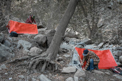 SE Emergency Tube Tent with steel pegs for quick shelter setup.