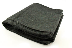 SE Green blanket spread on ground for shelter and comfort.