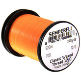 Semperfli Classic Waxed Thread 12/0 orange on spool, showing flat grip for secure fly tying