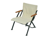 Snow Peak Beach Chair with wood armrests offers premium comfort on the sand for beach lounging.
