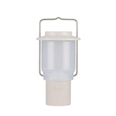 Snow Peak Mini Hozuki battery-powered lantern emitting warm ambient light at a campsite