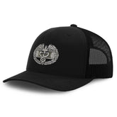 Close-up of Combat Medic Badge embroidery on black low crown mesh snapback hat
